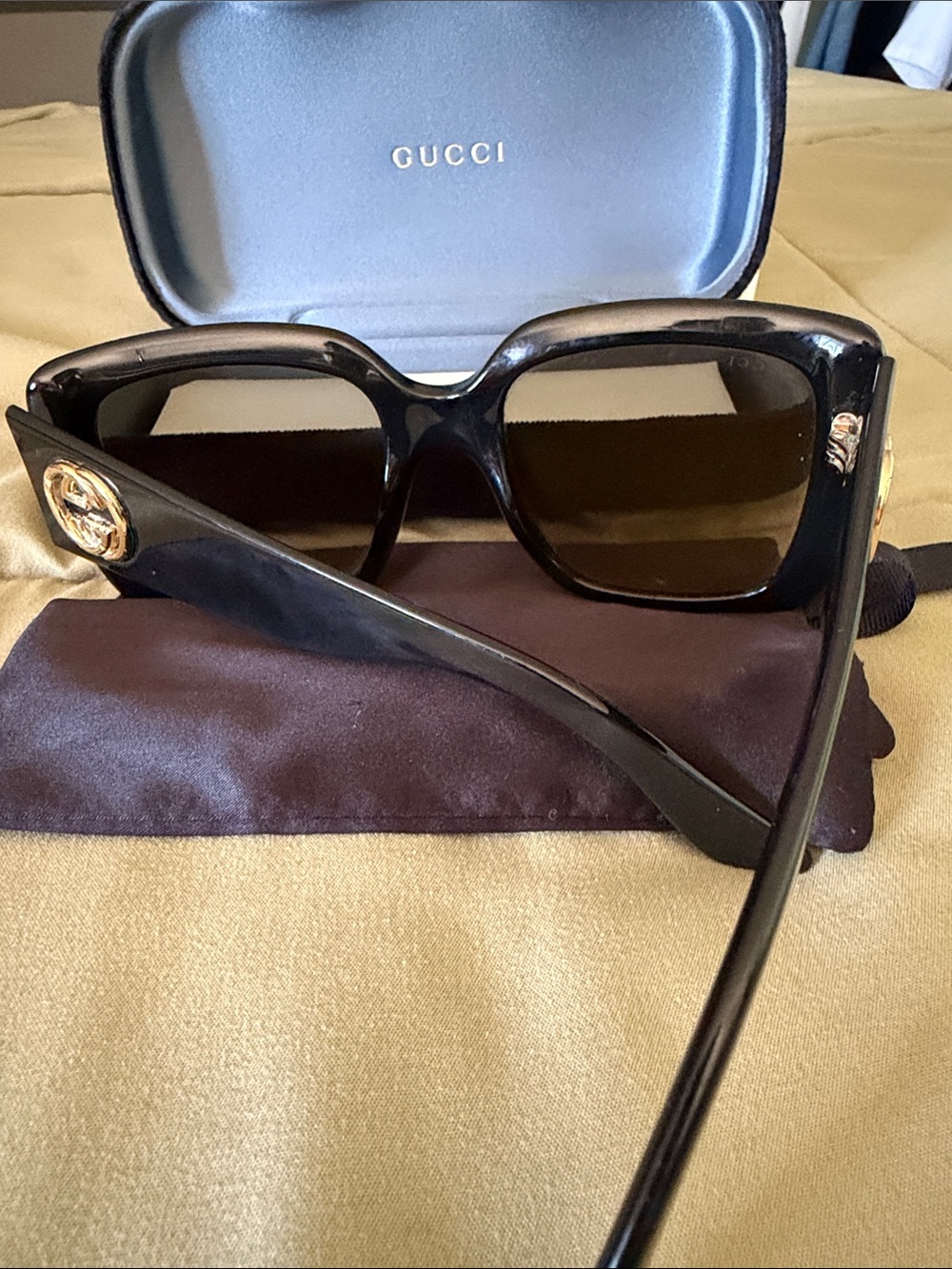 Gucci Women’s Black Sunglasses with Gold Medallion Accent